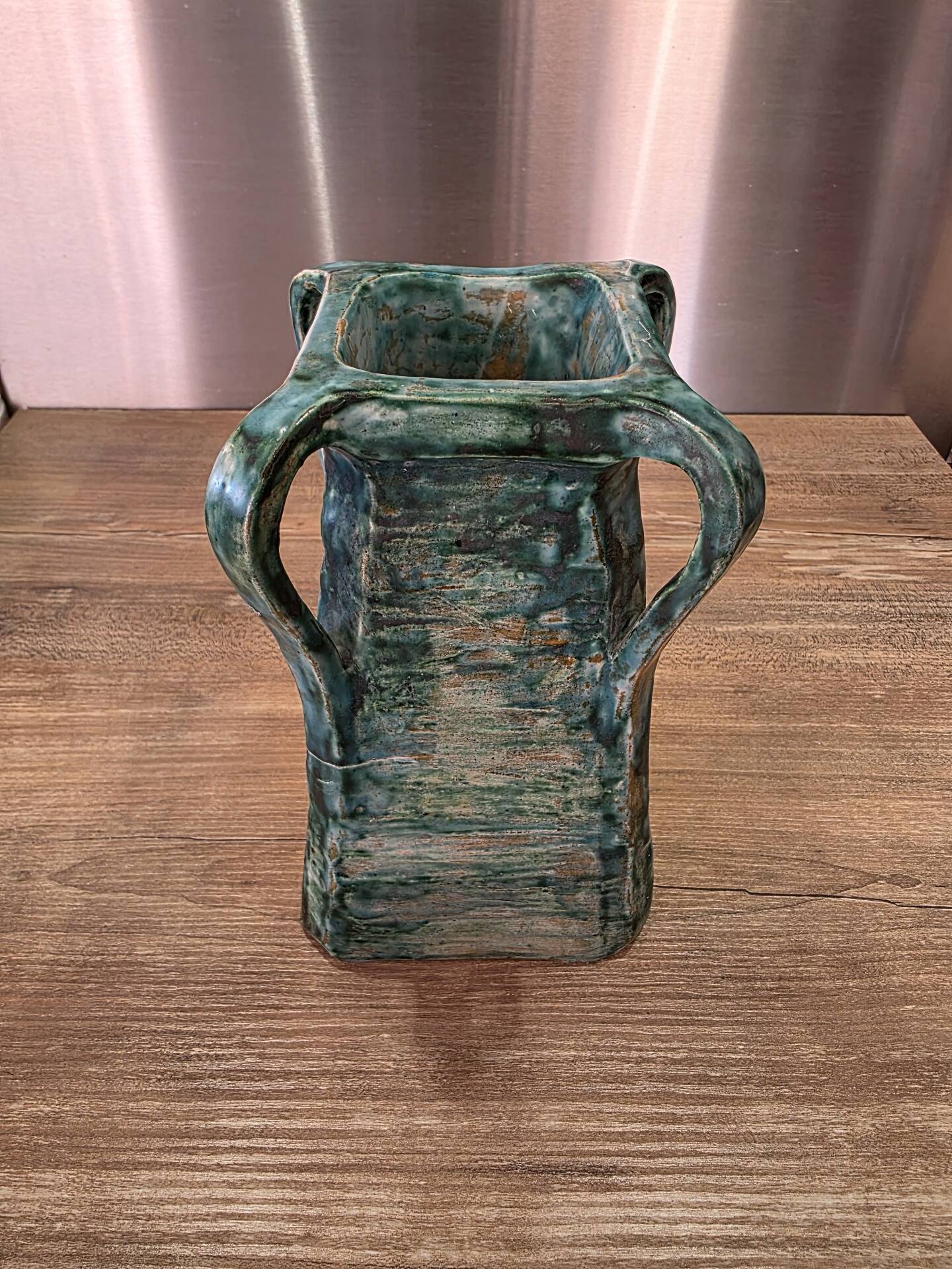 Vintage brutalist ceramic vase with 4 green handles.