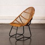 Rattan armchair with metal legs