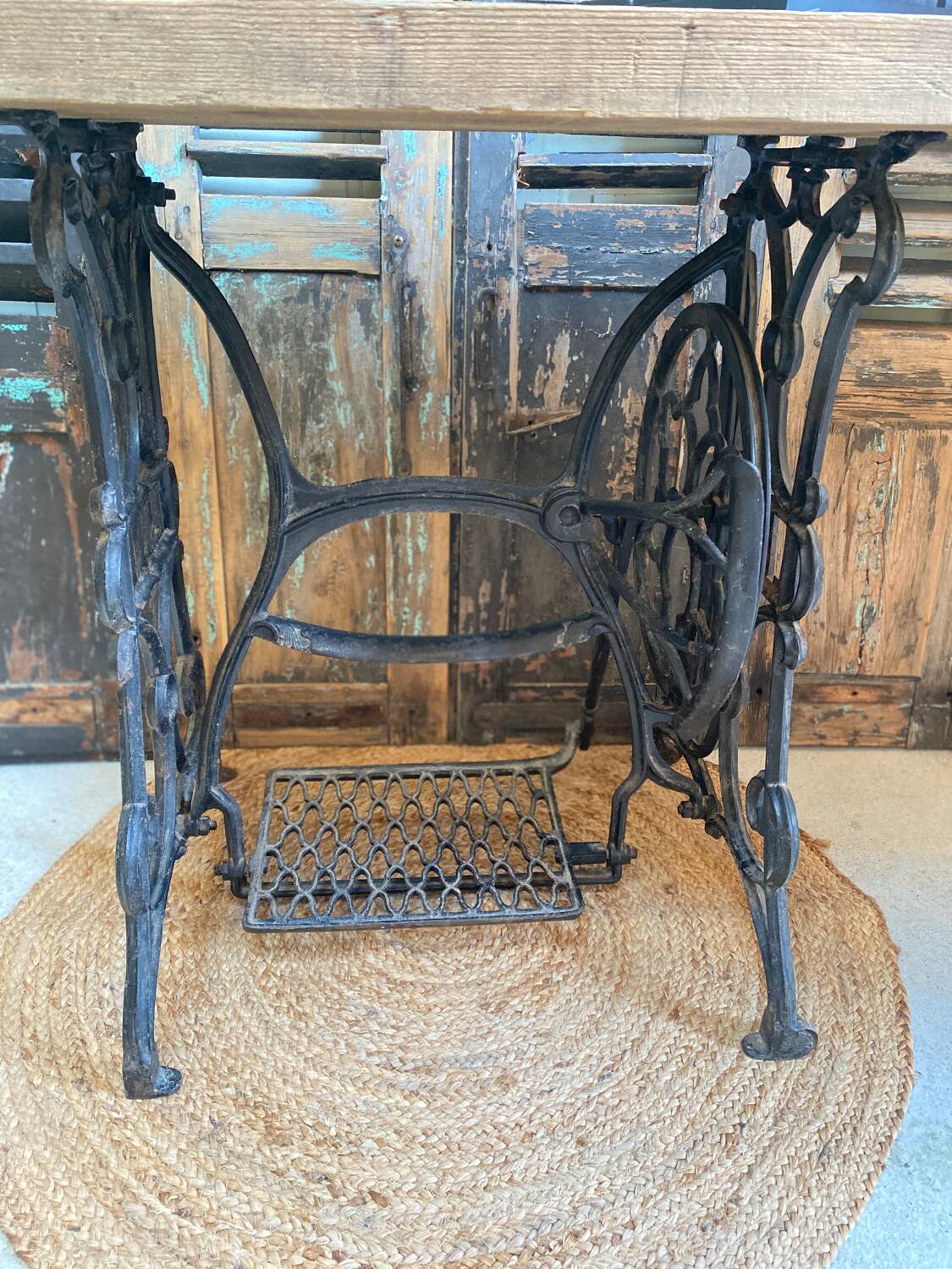 Vintage wooden table with a cast iron base.