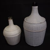 Pair of white covered demijohns