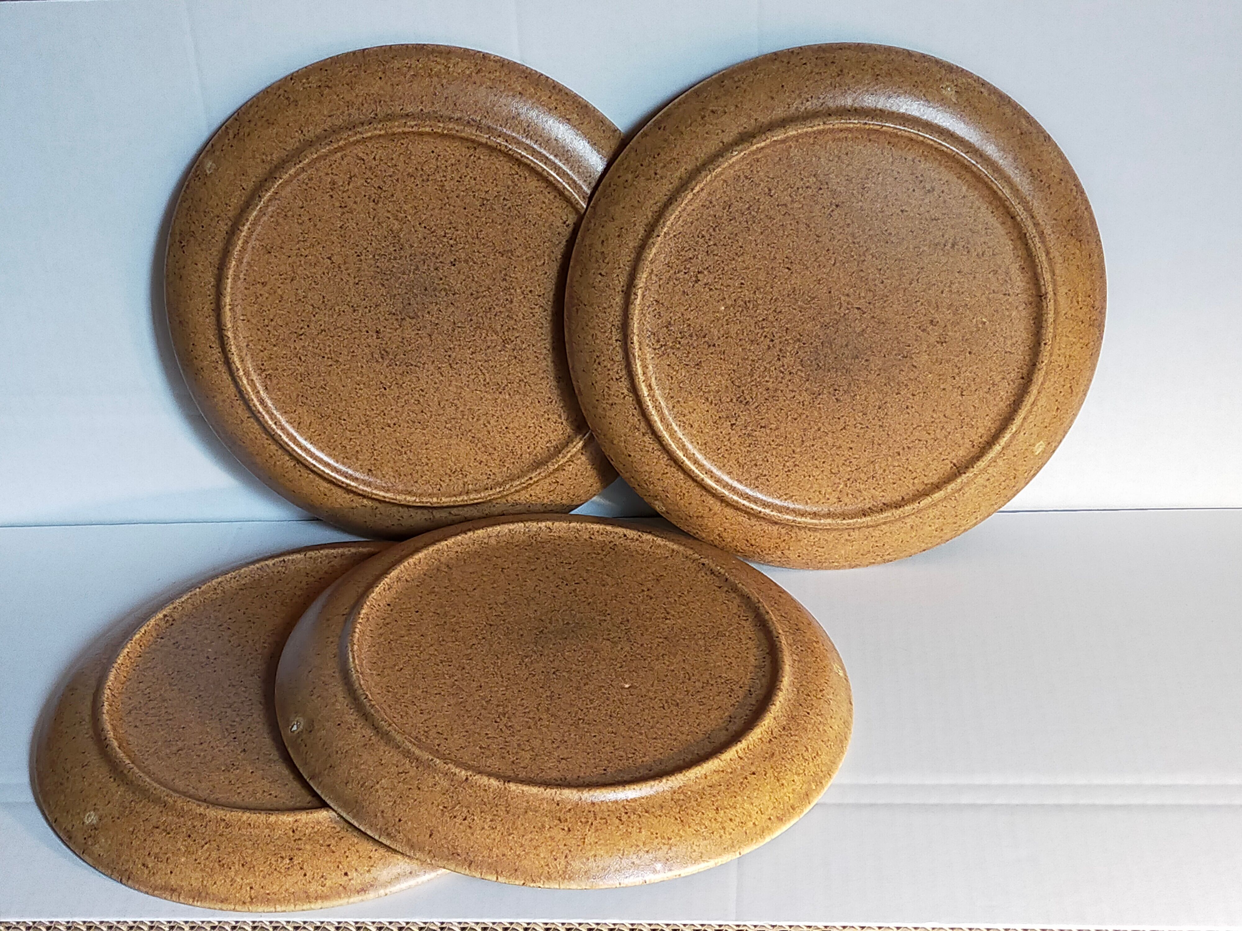 Four vintage glazed stoneware potter's plates