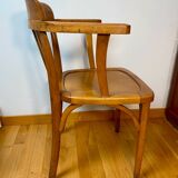 Antique curved wooden armchair in Baumann style