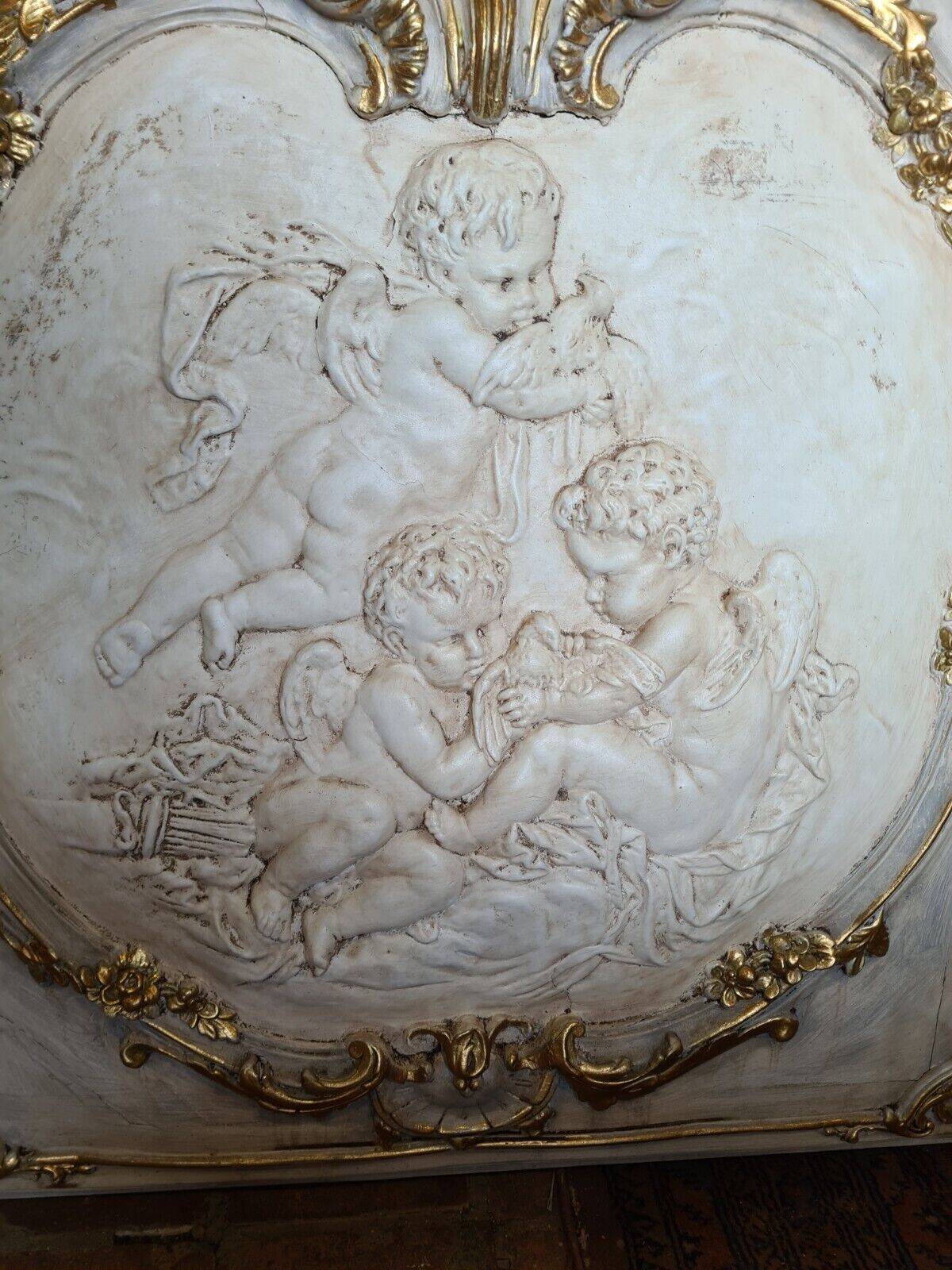 wall panel with angels in stucco and weathered wood