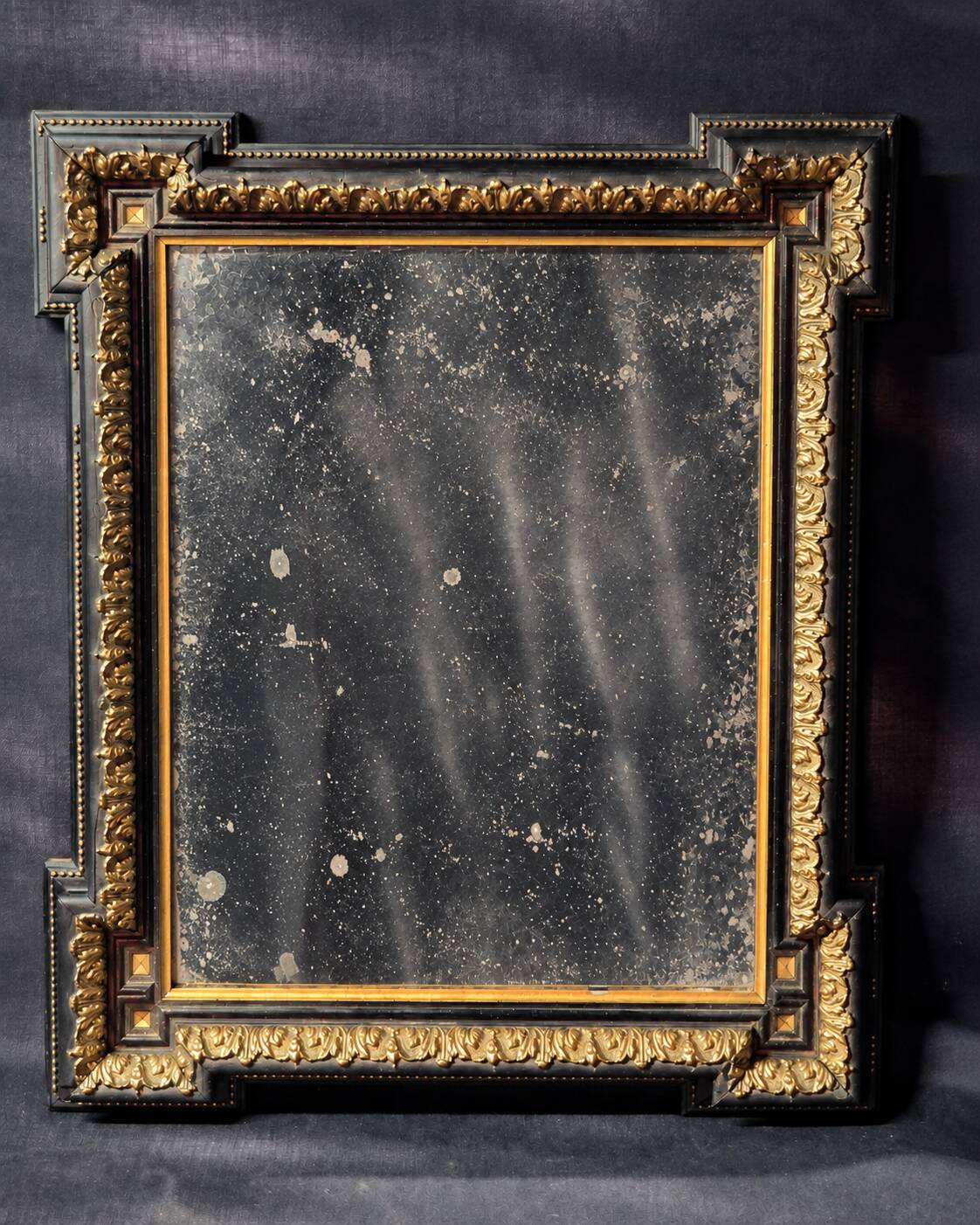 Napoleon III mirror in blackened wood and gilded decoration, second half of the 19th century.
