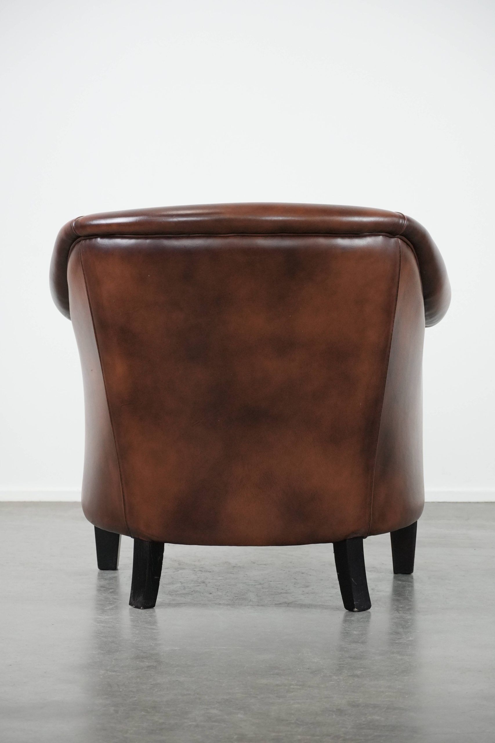 Great luxurious brown cowhide club armchair with matching piping