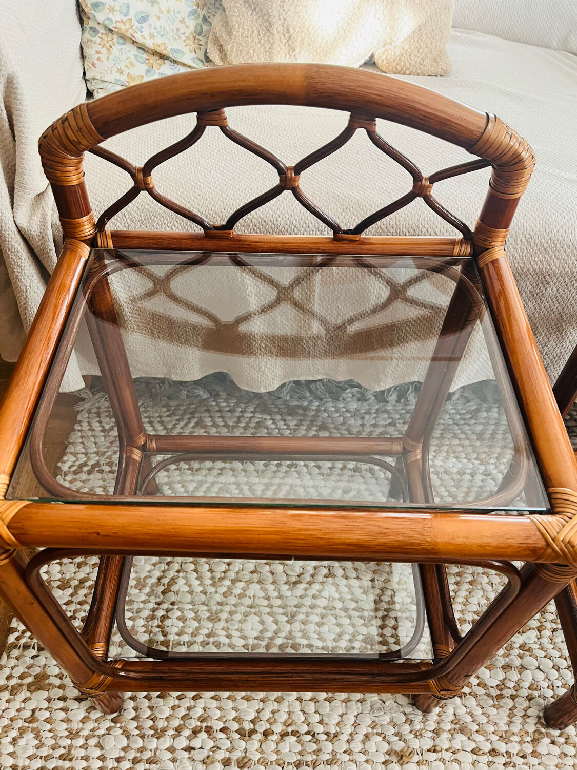 Two rattan and glass bedside tables