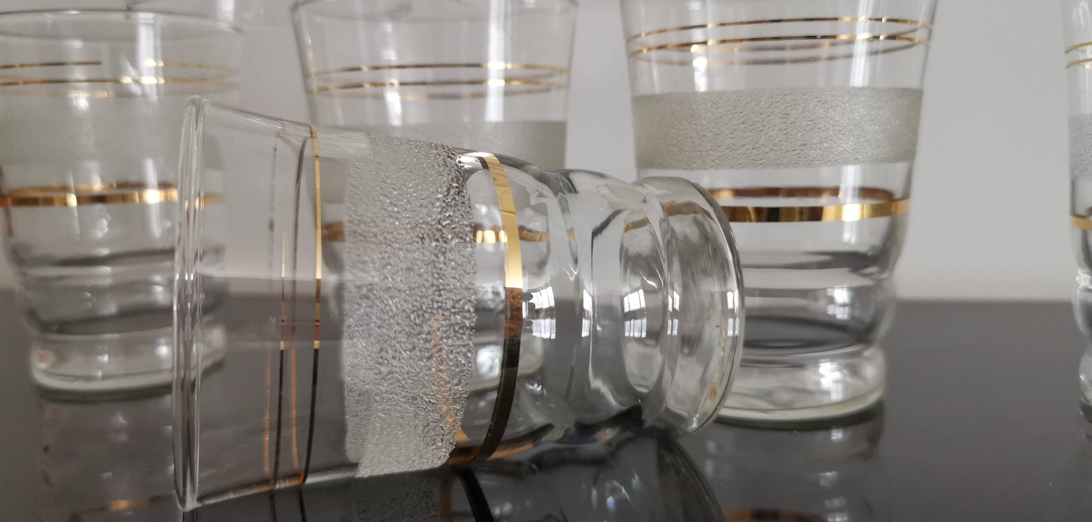 8 glasses with white granite band and gold edging from the 1950s