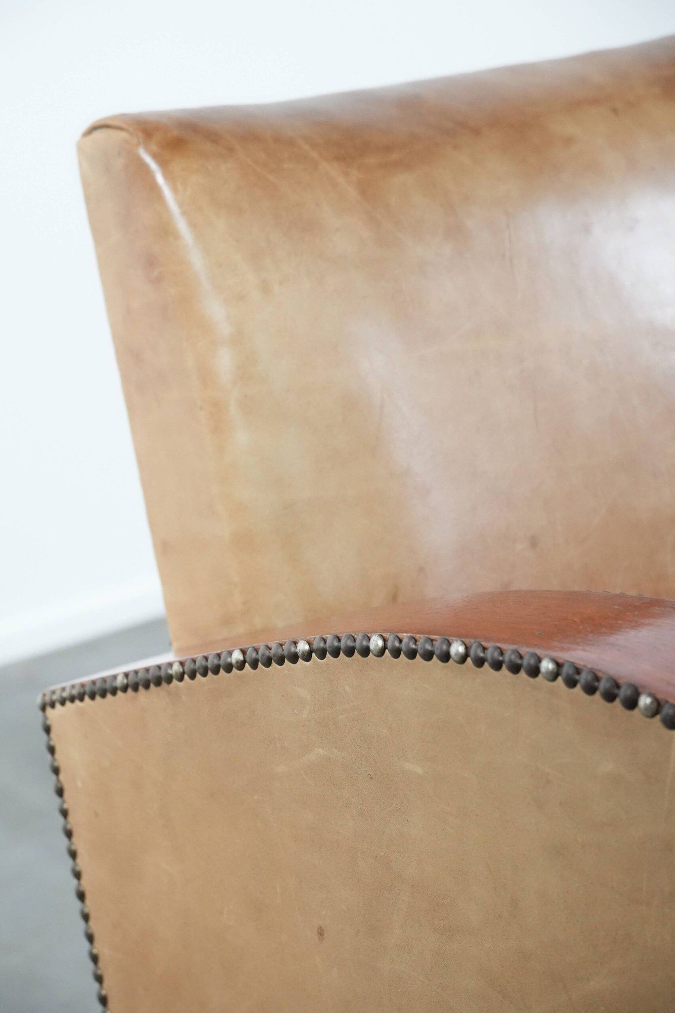 Art Deco design armchair in light cognac cowhide leather.