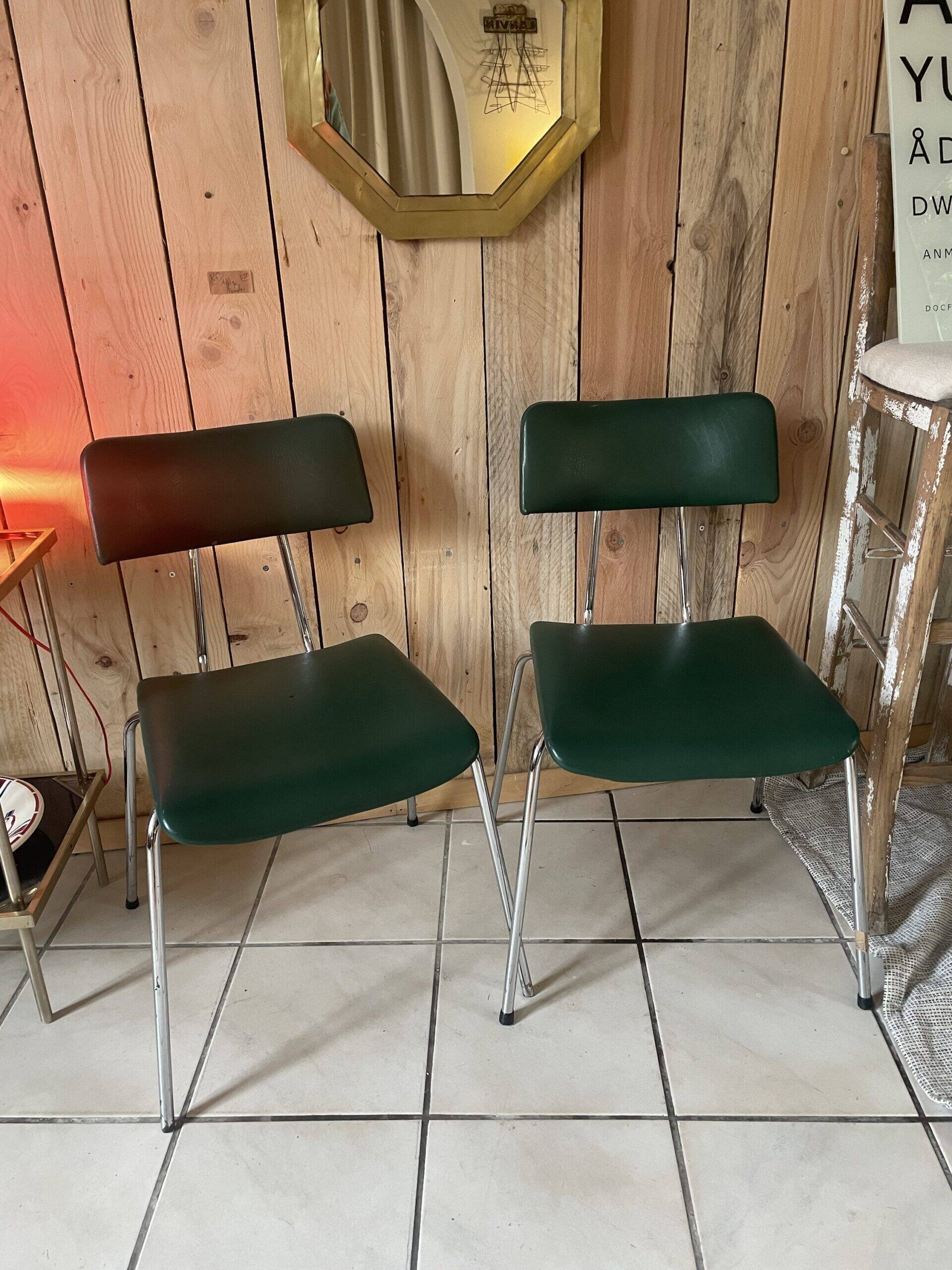 Pair of green faux leather chairs