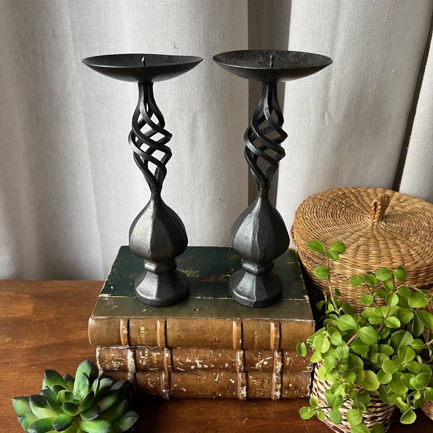 Pair of wrought iron candlesticks, black patina