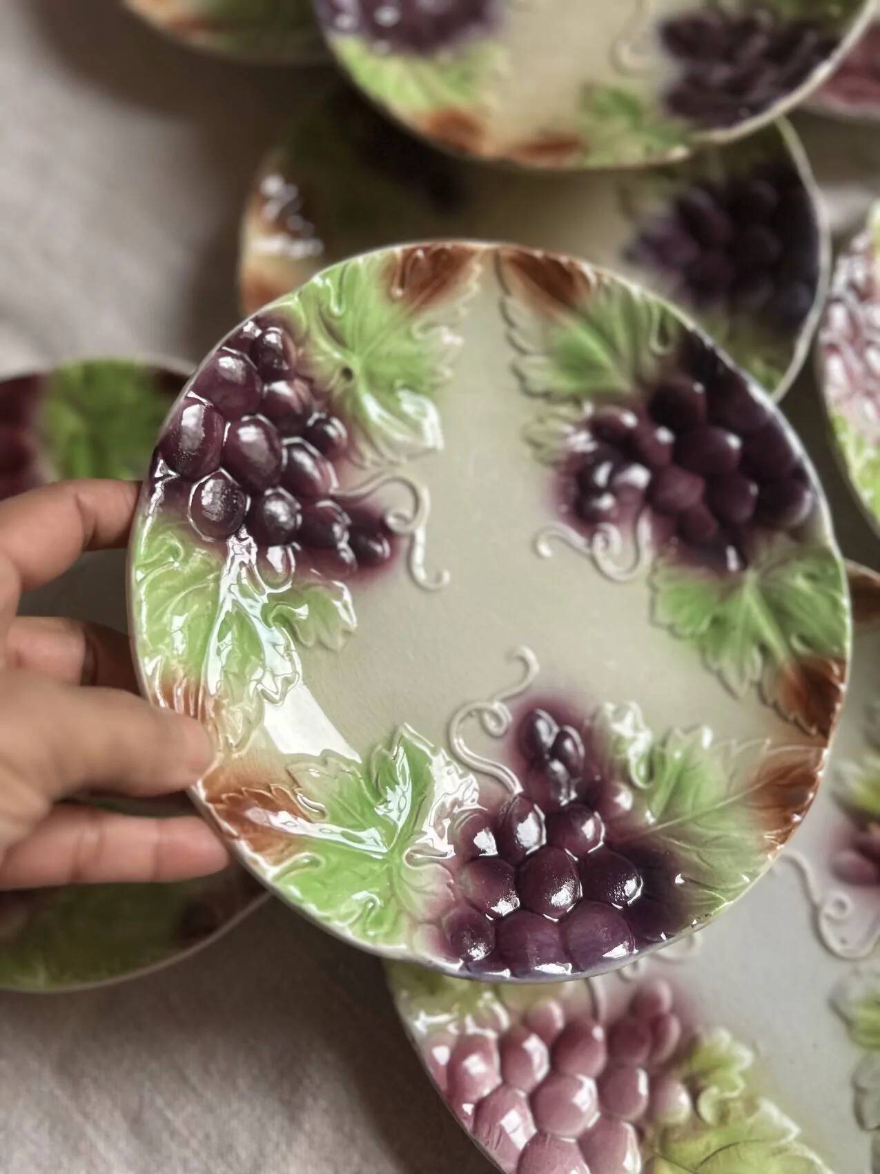 Set of eight flat dessert plates in barbotine earthenware with grape decoration – circa 1900.