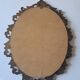 Painted under glass convex medallion in bronze