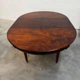 Extendable mahogany round table in Louis XVI style