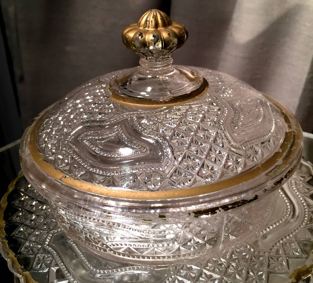 Butter dish or candy dish in pressed glass molded with golden rim