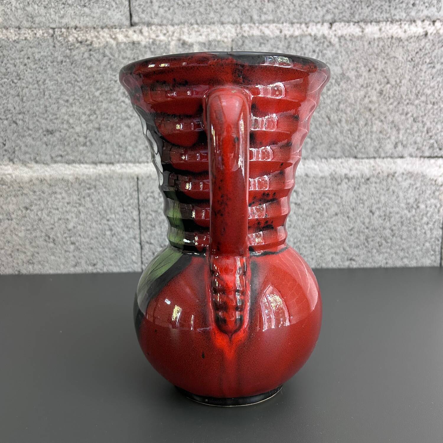 Red vase with floral decoration