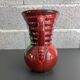 Red vase with floral decoration