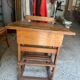 Old school desk with integrated adjustable seat.