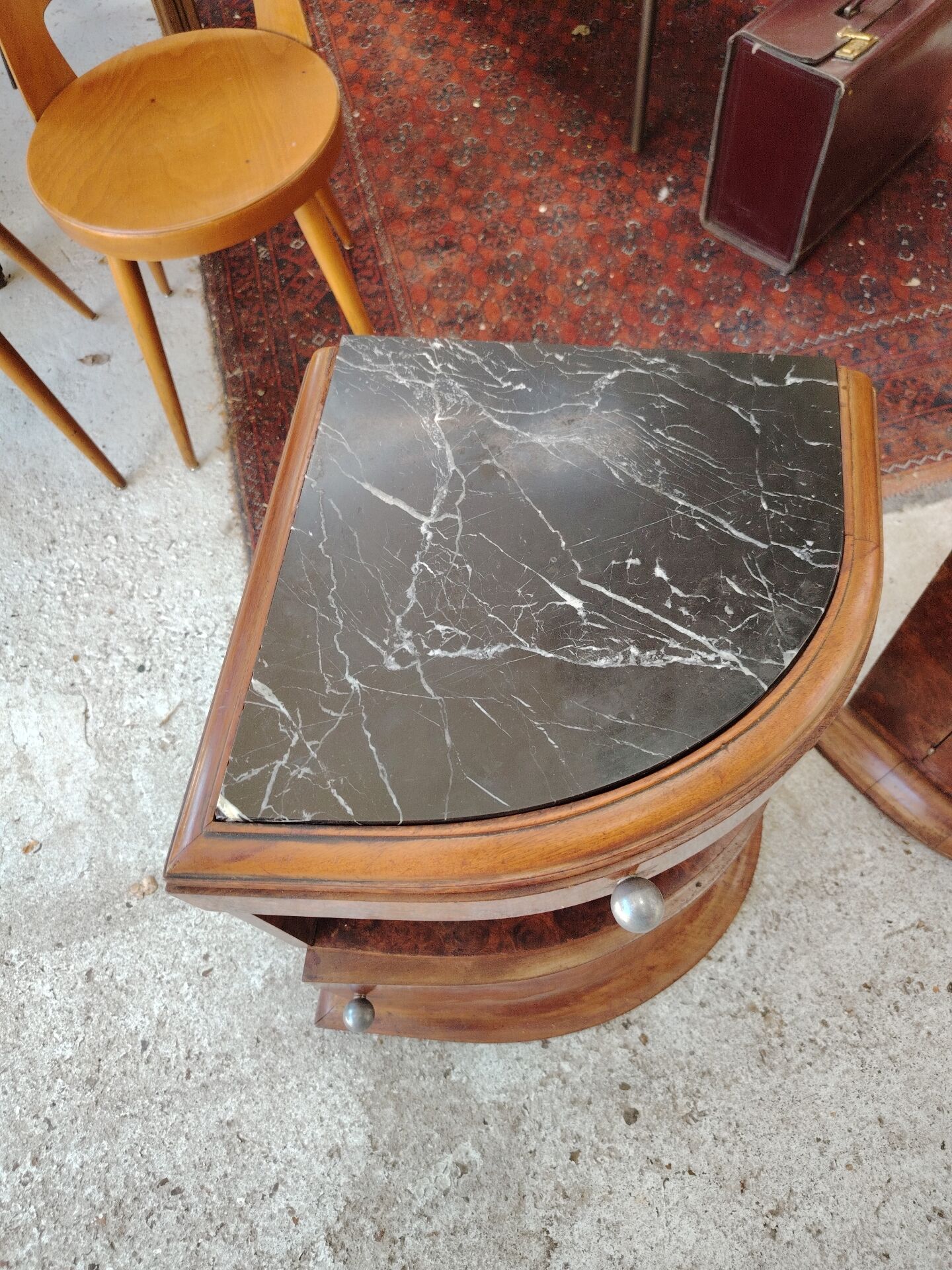 Pair of Art Deco half-moon bedside tables in walnut veneer and black marble.