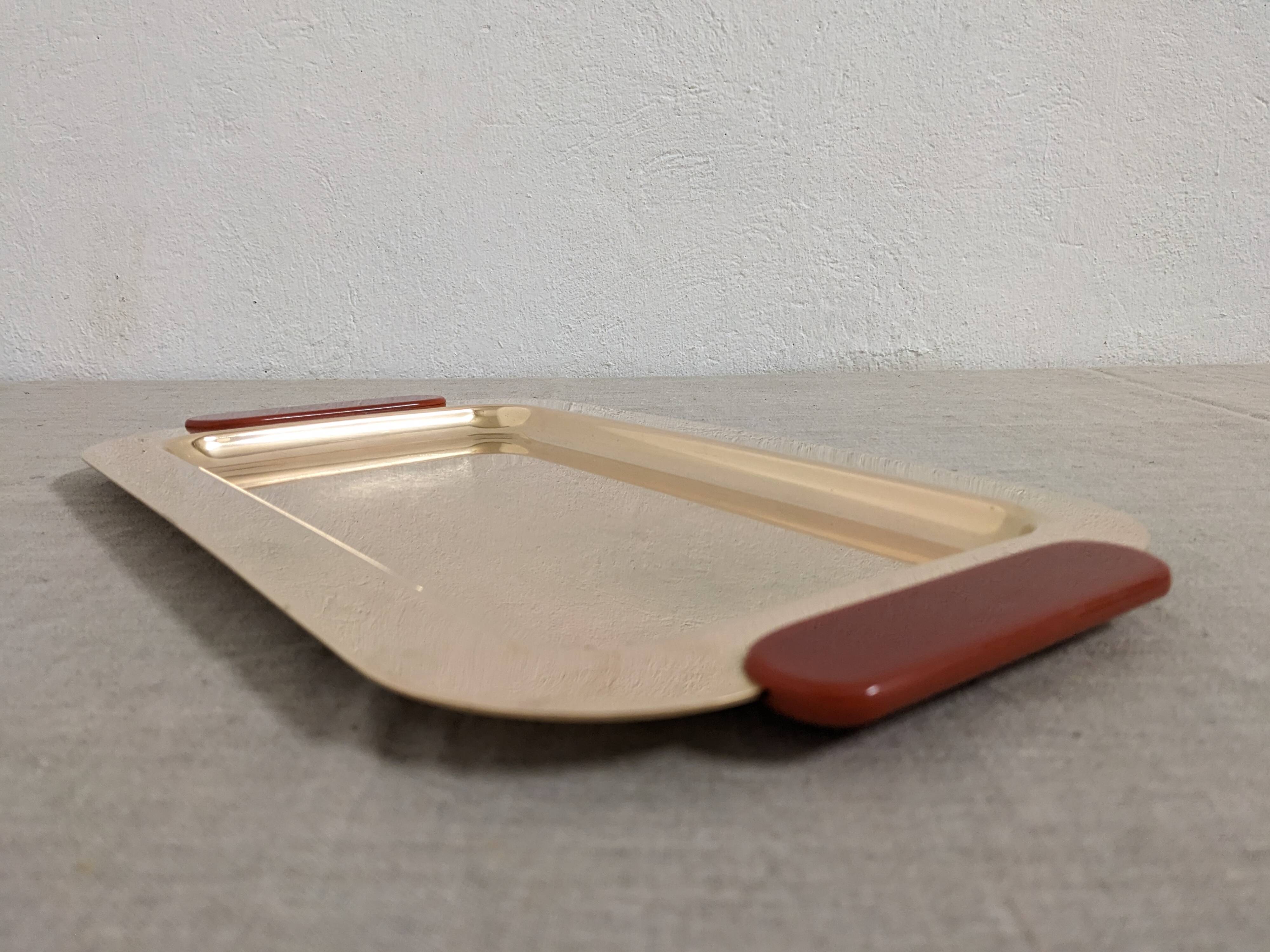 Plates and a brass and Bakelite cut by PM Italy, Italy around 1970.