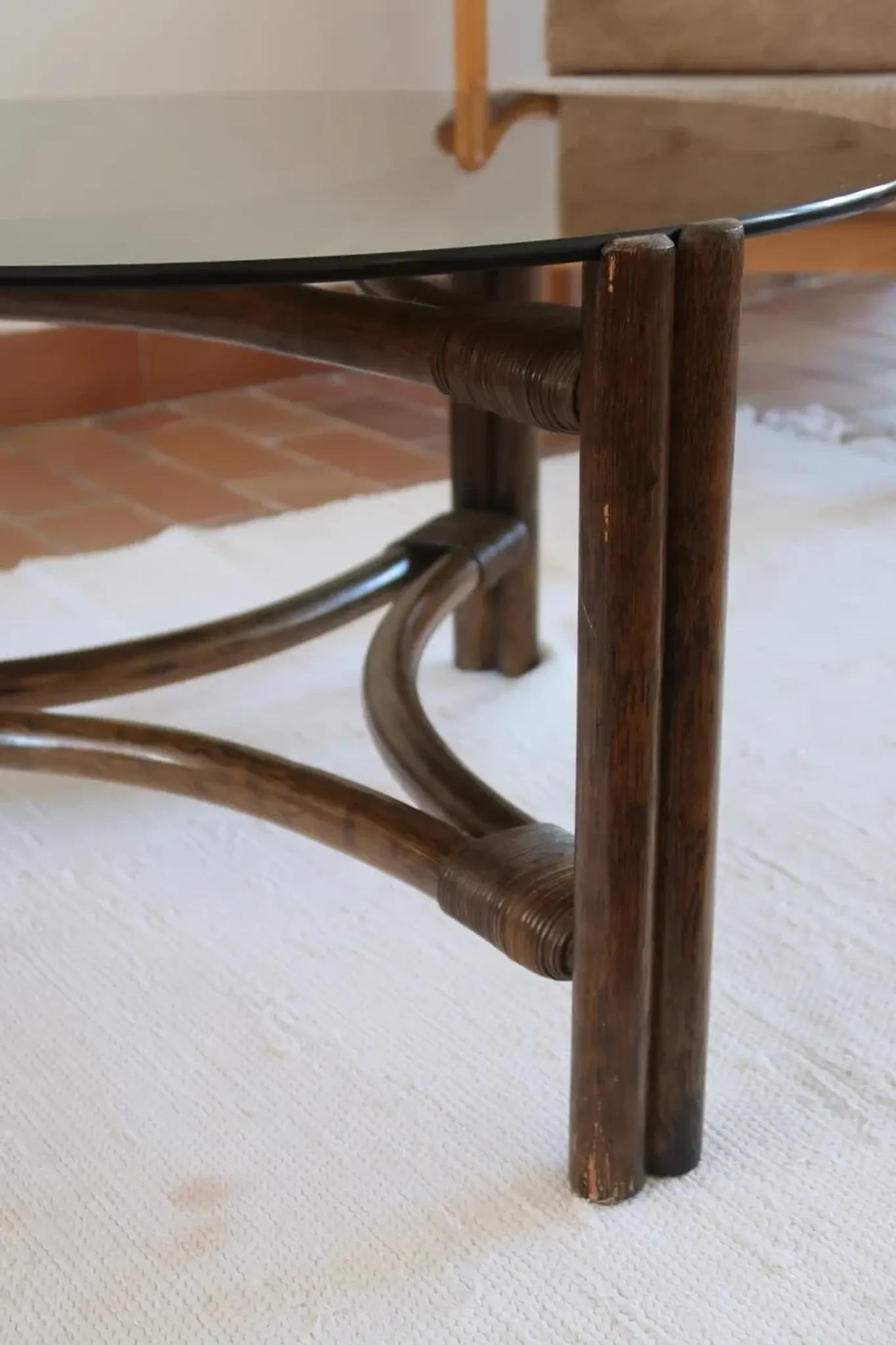 Round coffee table in rattan and smoked glass — 1970s