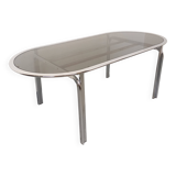 Vintage oval dining table in smoked glass and chrome metal, Space Age style.