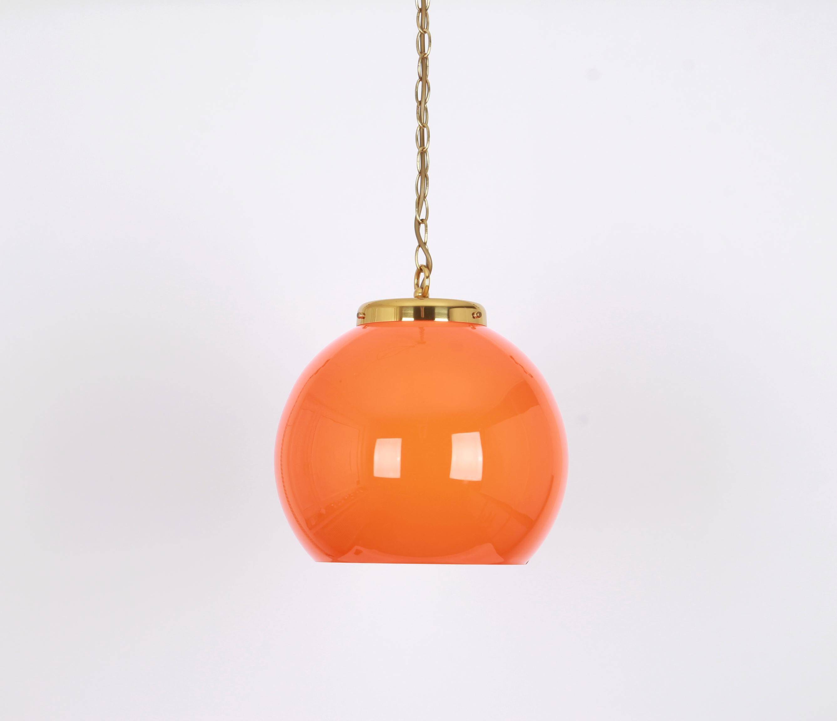 Orange glass pendant light by Peill Putzler, Germany, 1970.