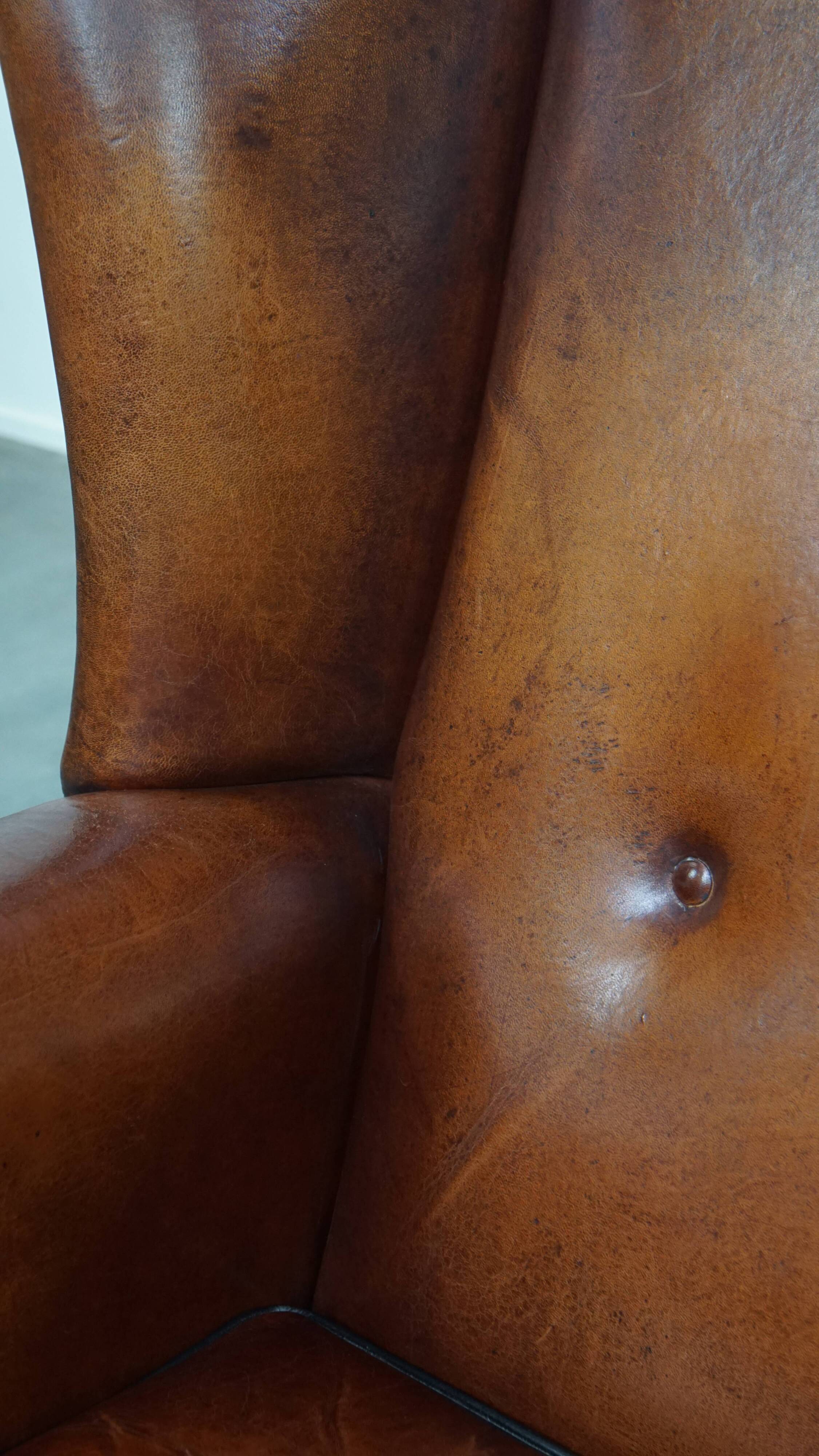 Sheepskin Wingback Chair with Warm Tones and Black Piping