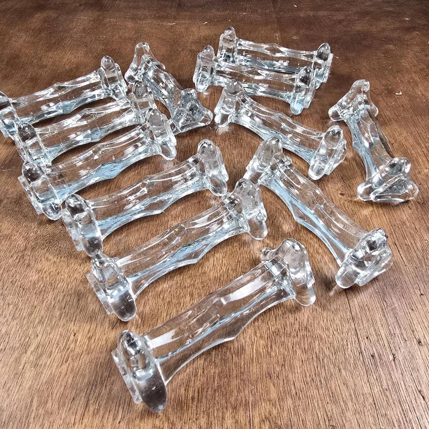 Set of 12 antique knife and fork rests in thick transparent glass.