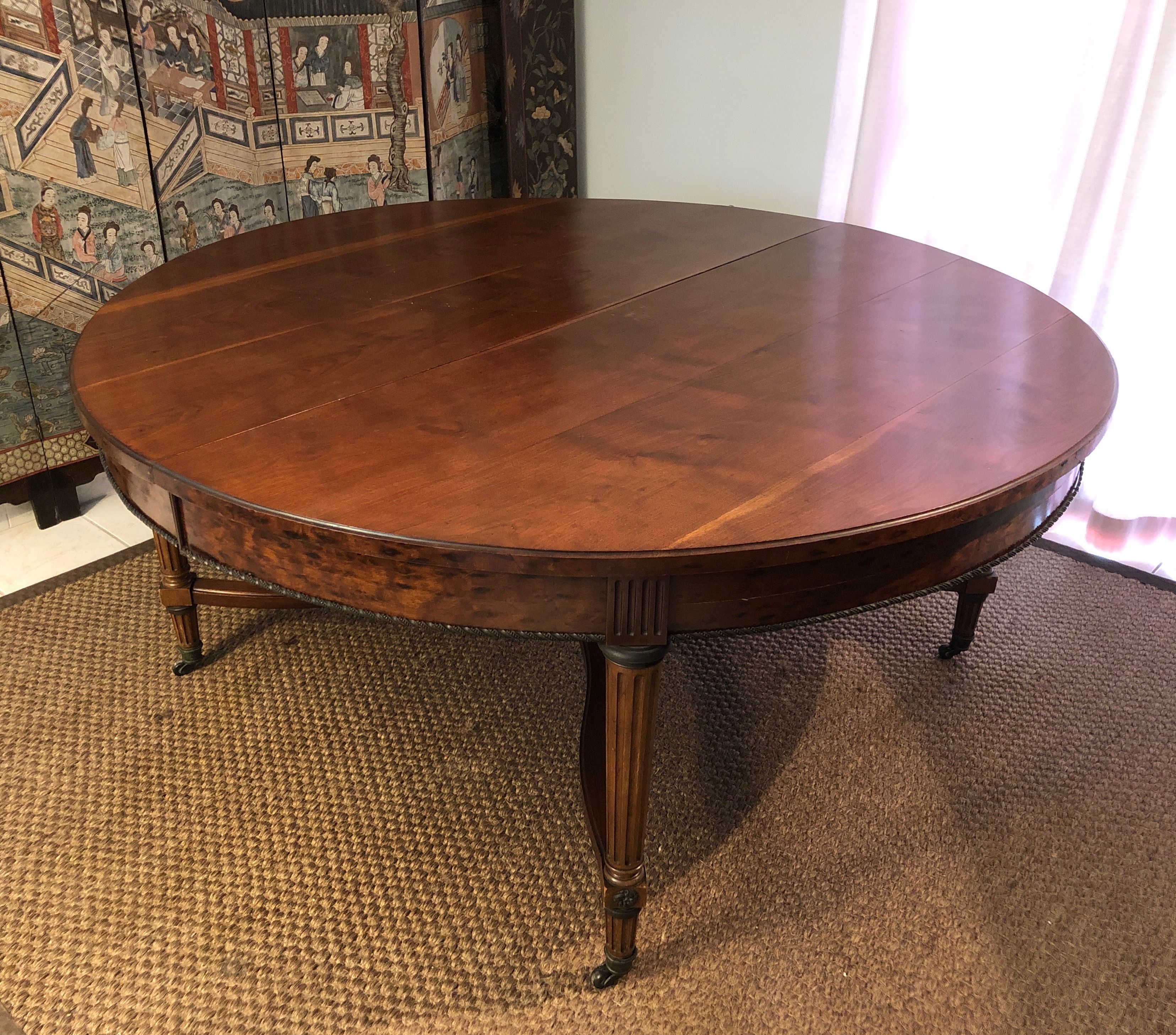 Important central pedestal table in mahogany, brass and bronze that can form a large dining table.