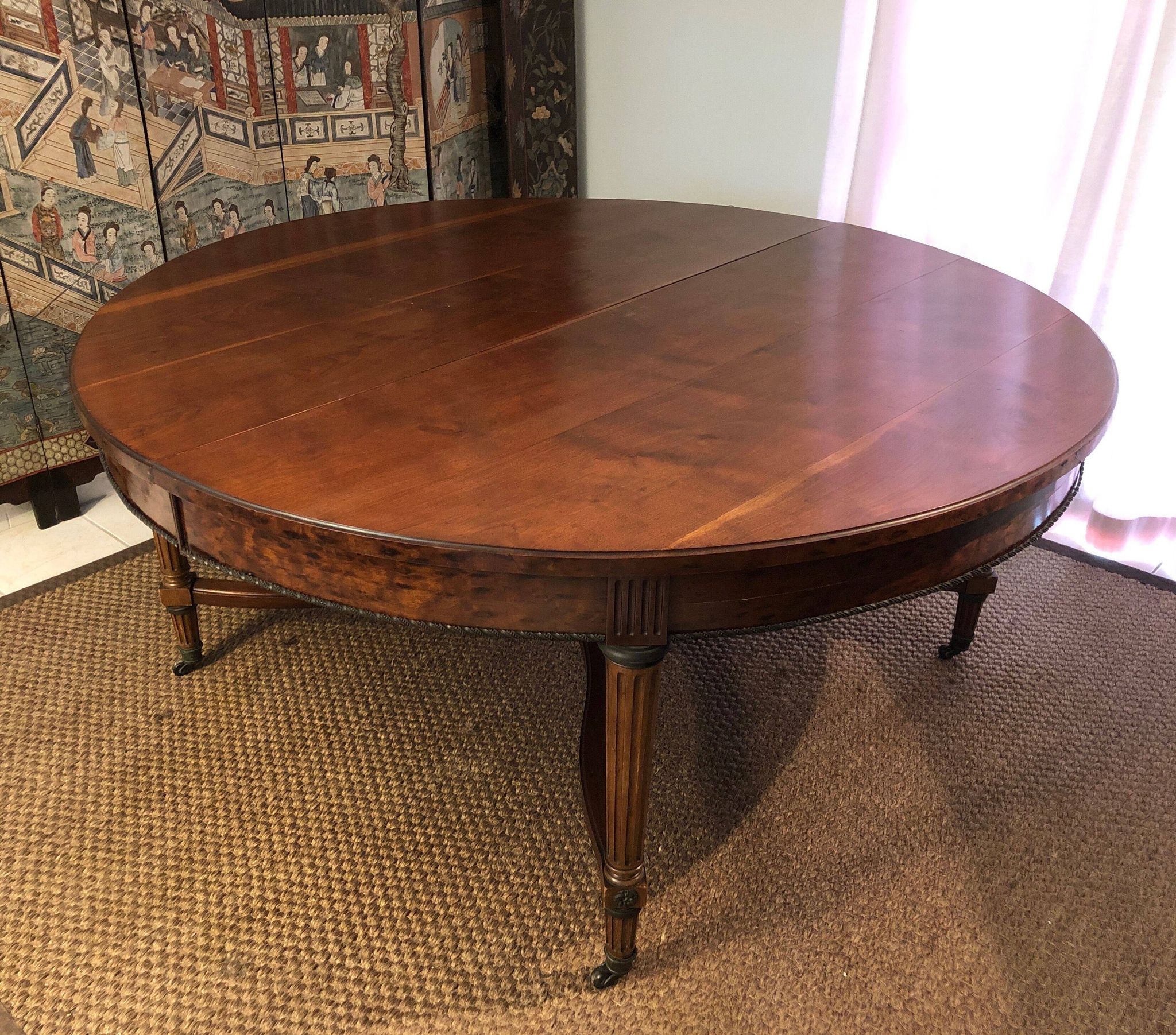 Important central pedestal table in mahogany, brass and bronze that can form a large dining table.