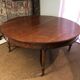 Important central pedestal table in mahogany, brass and bronze that can form a large dining table.