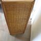 Storage column, wooden bookshelf and woven rattan.