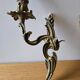 Pair of symmetrical gold wall sconces in baroque style made of bronze.