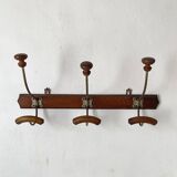 Antique wall-mounted coat rack in wood and metal