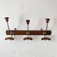 Old wooden and metal wall-mounted coat rack.