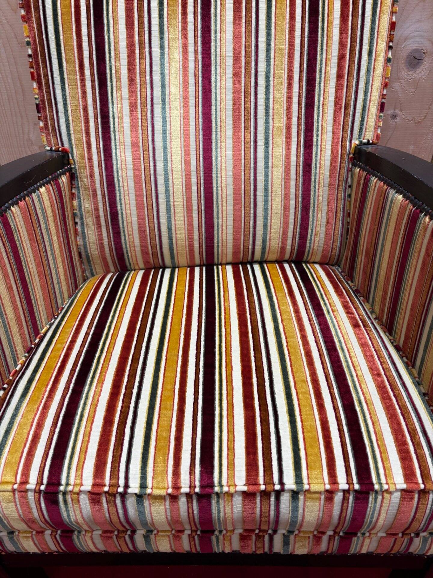 Art Deco armchair in multicolored striped fabric and its footrest
