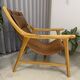 Colonial armchair in leather and wood