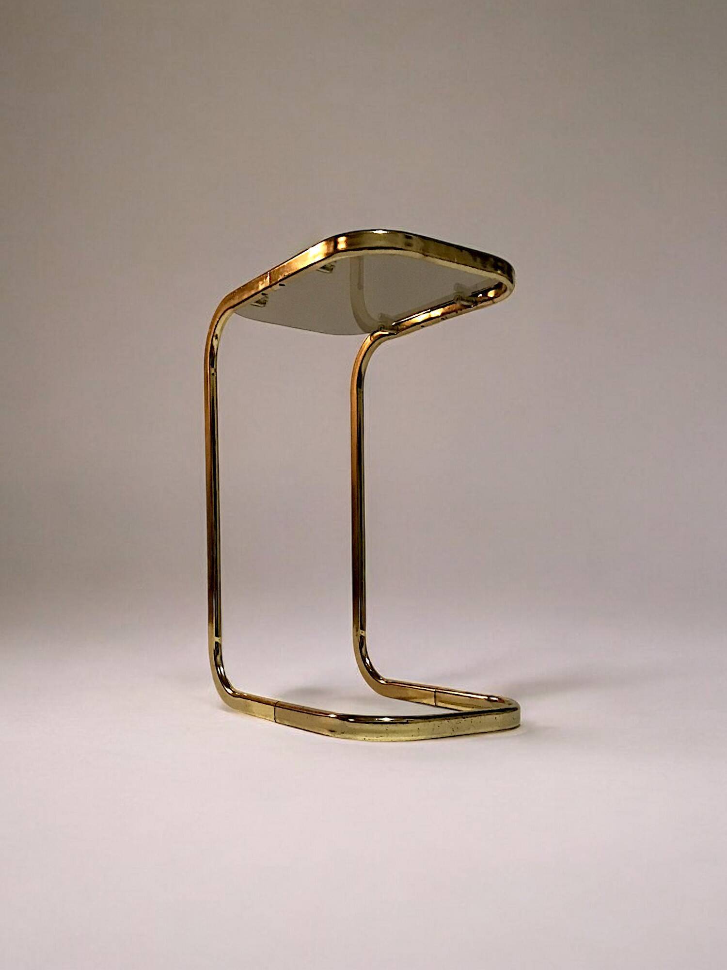 C. 1970 - Pair of side tables in gilded metal and smoked glass -