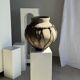 Very large light grey terracotta pot with handles and rattan crossbars.