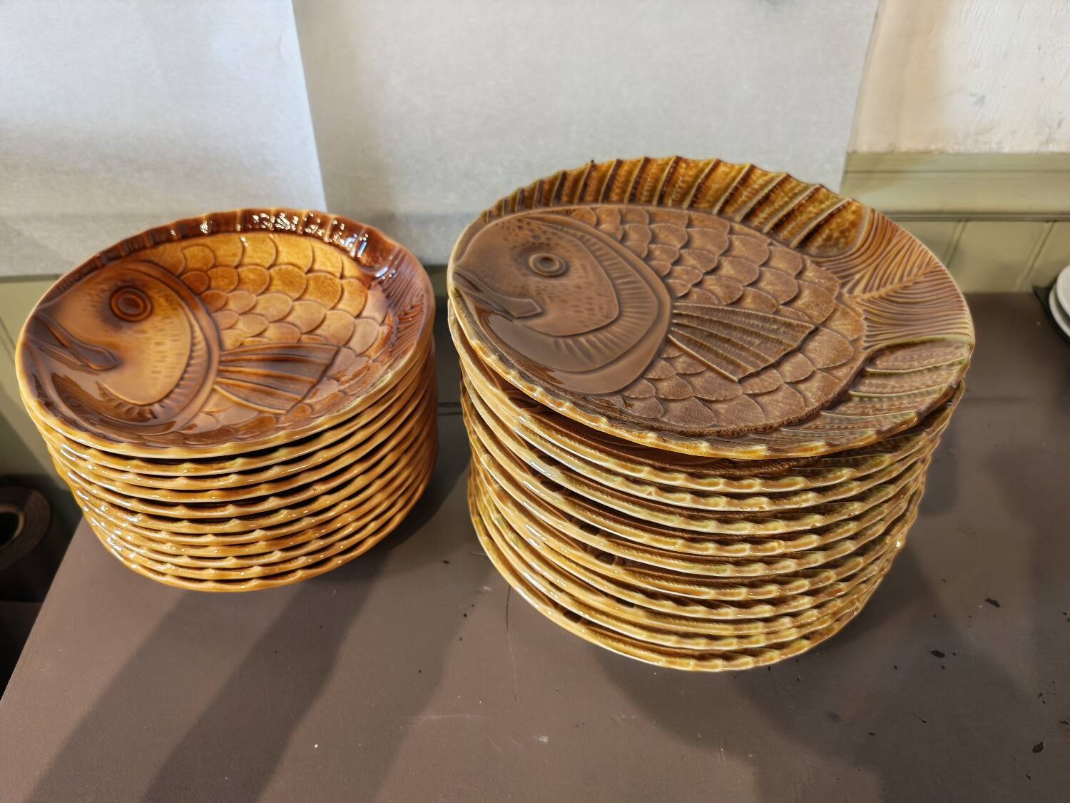 Vintage barbotine plates with fish decoration, 22 pieces.