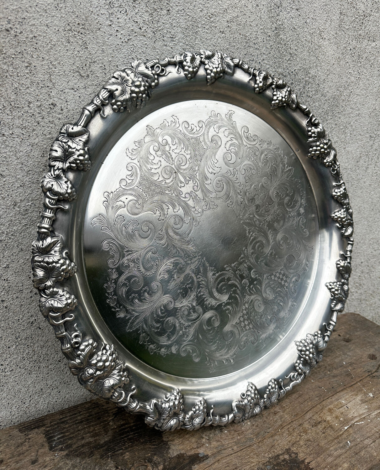 Antique round silver serving platter, grape motifs.