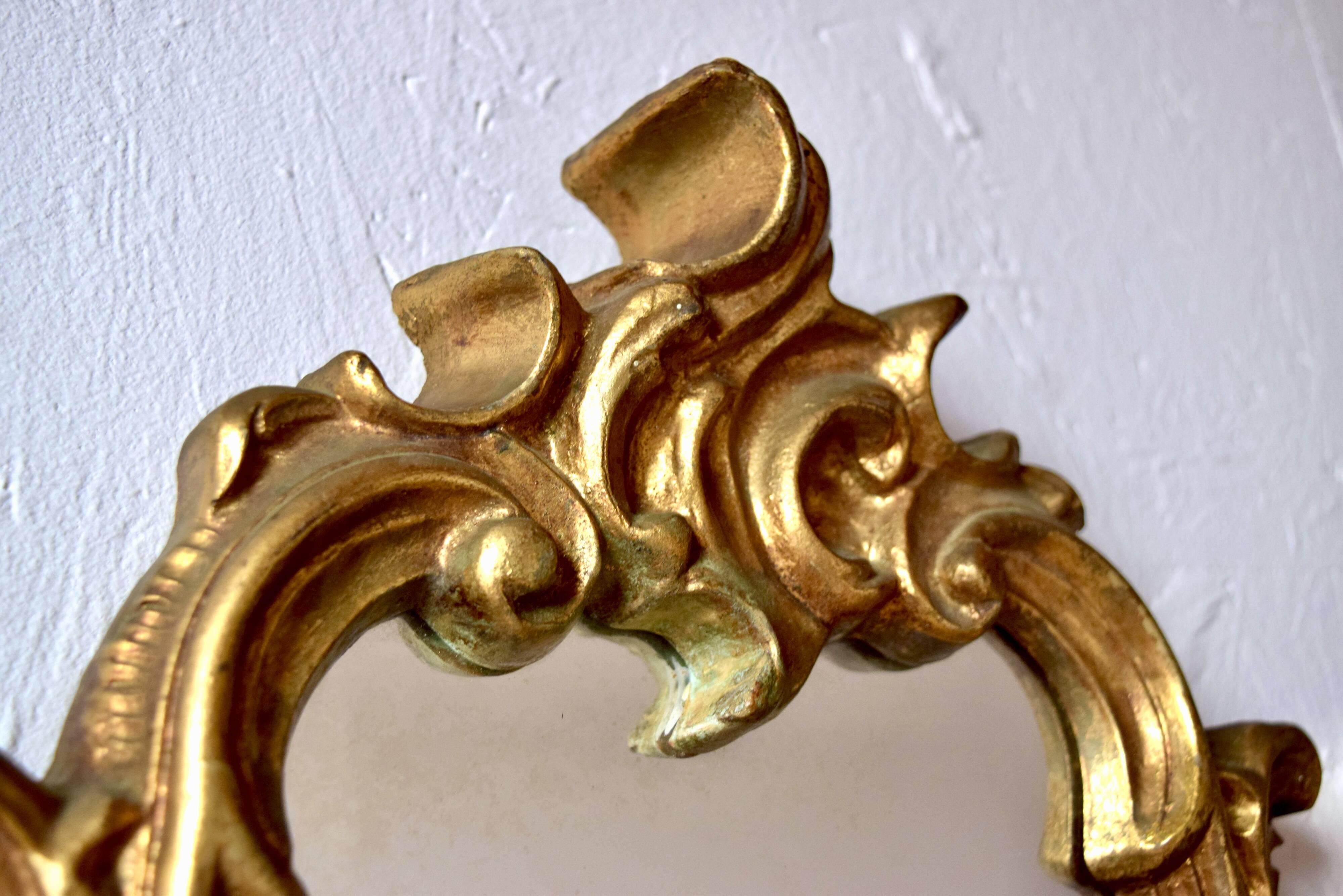 Large rococo mirror in gold painted wood
