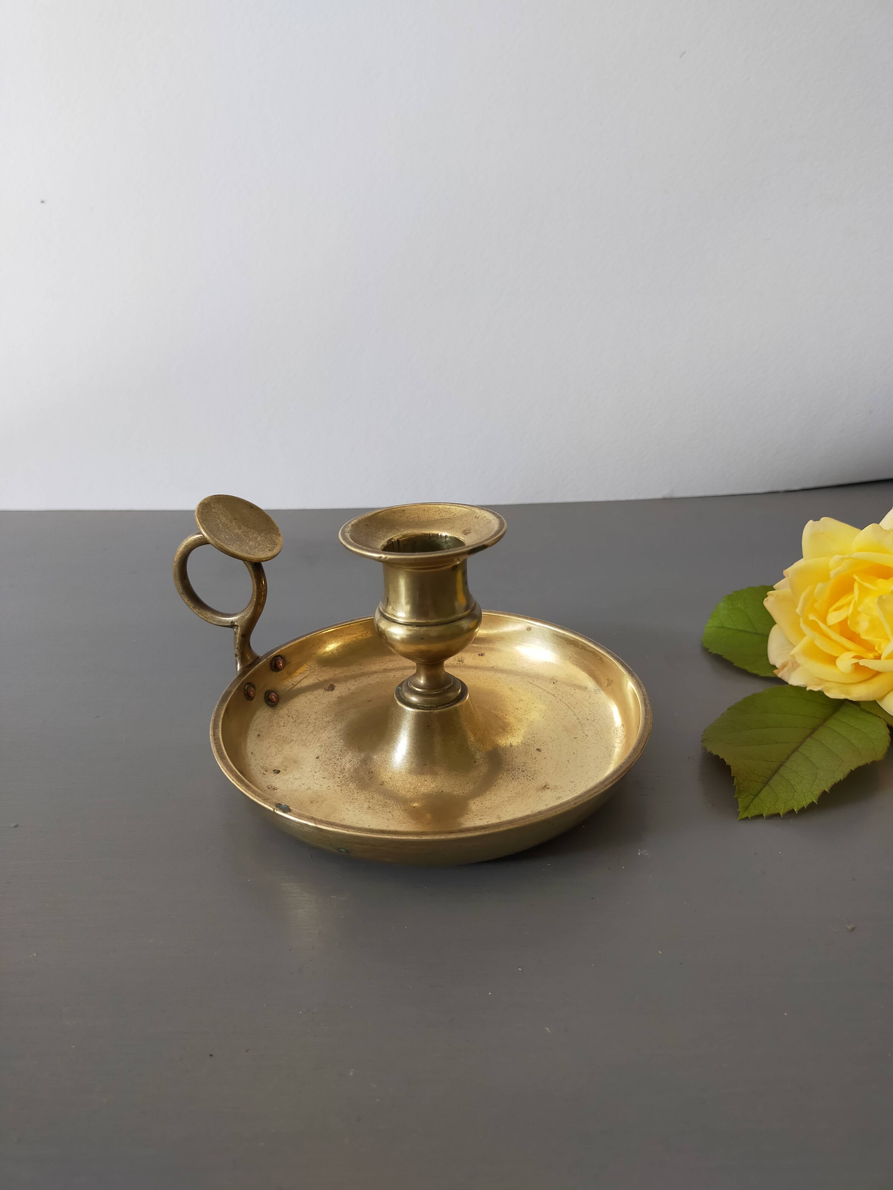 brass candle holder with old cellar rat thumb