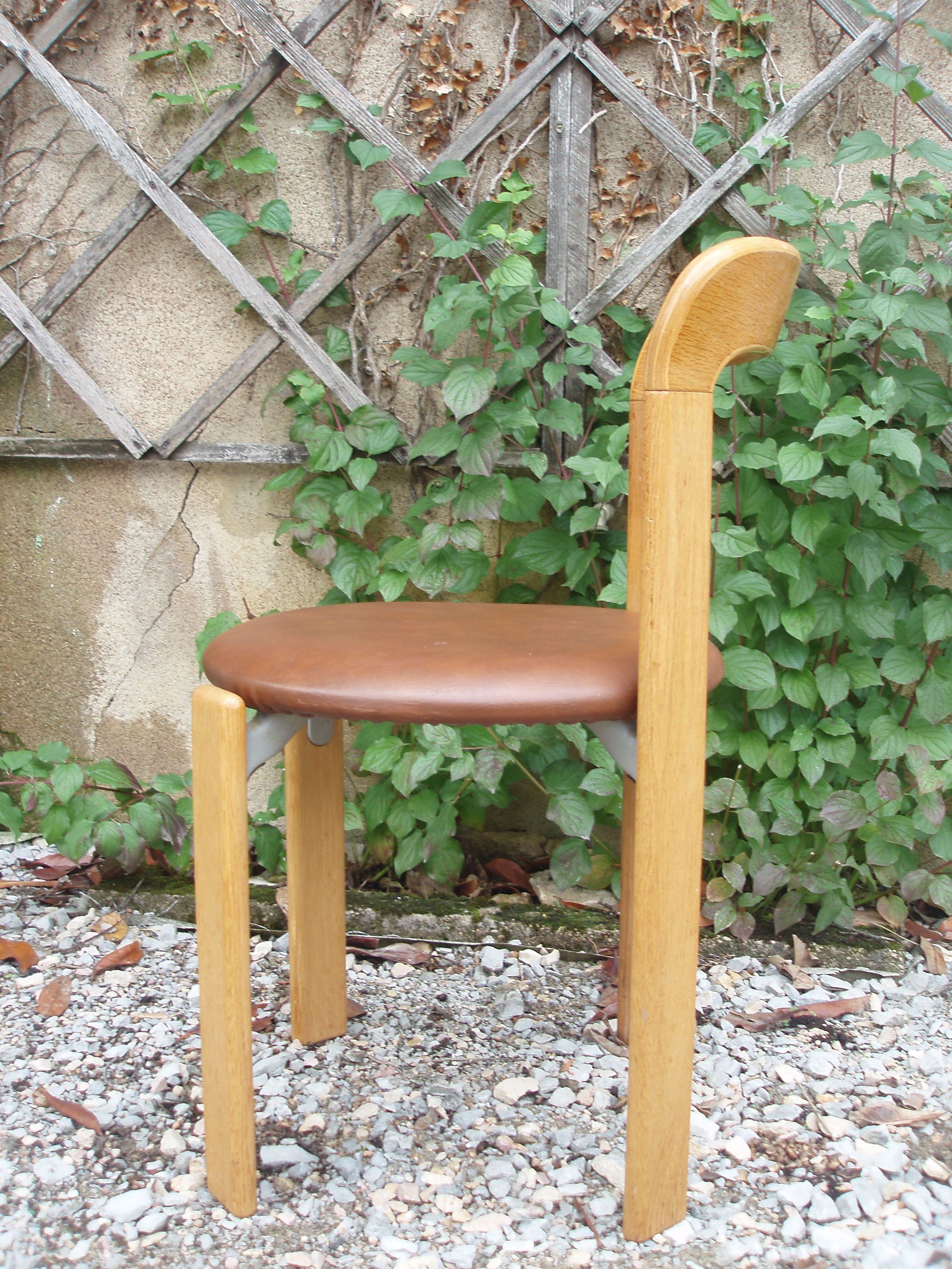 Pair of chairs by Swiss designer Bruno Rey in wood and brown skai