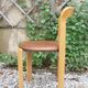 Pair of chairs by Swiss designer Bruno Rey in wood and brown skai