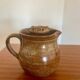 Large antique brown glazed stoneware jug with cork stopper.