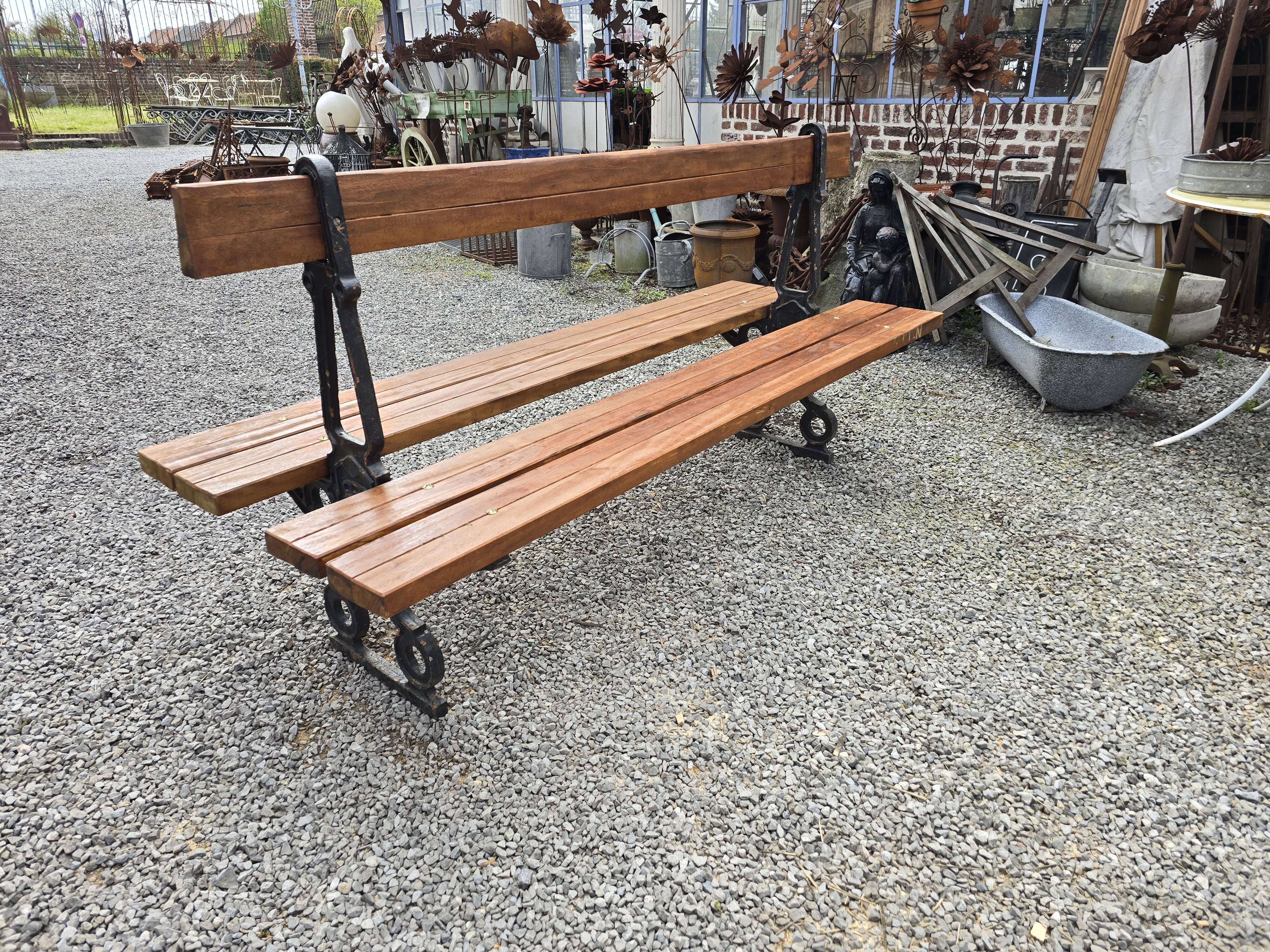 Antique double garden bench from the city of Paris in cast iron and wood