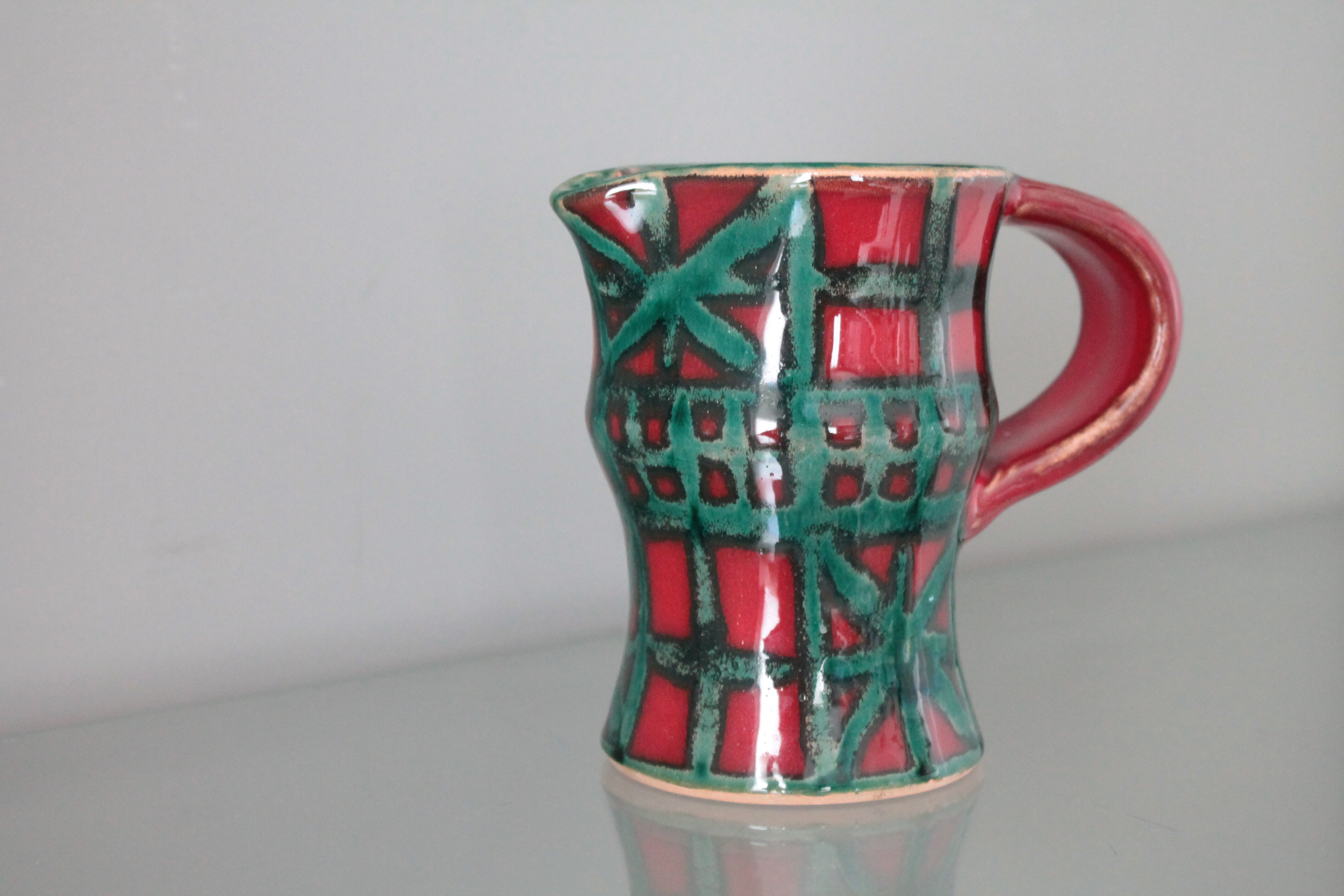 Vintage pitcher red and green art pottery