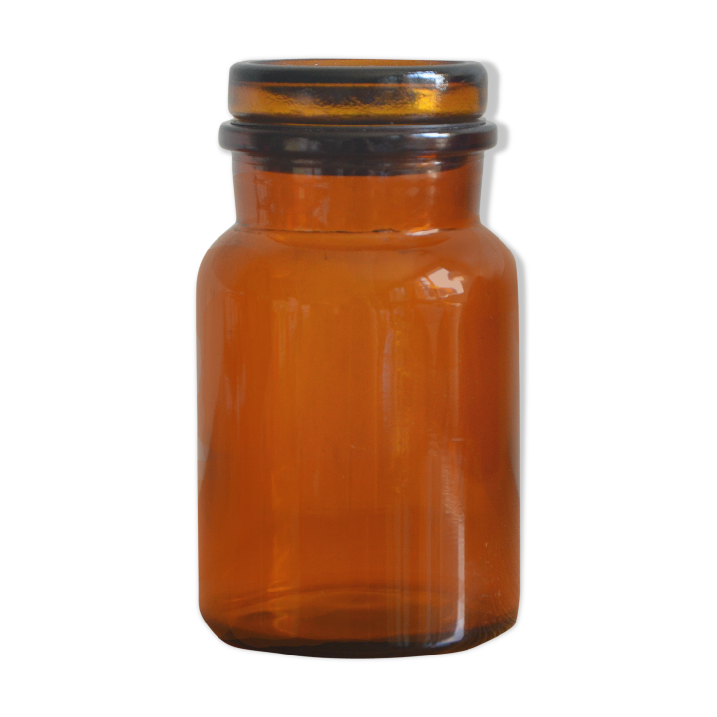 Small jar of amber glass apothecary with a flat cap