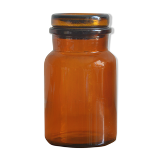 Small jar of amber glass apothecary with a flat cap